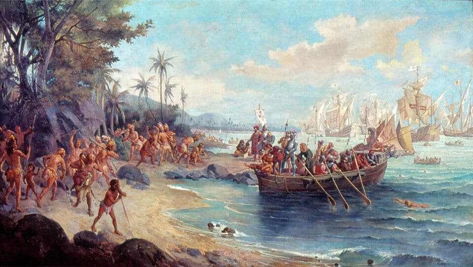 Pintura de navegadores portugueses a desembarcar de um batel numa praia, com indígenas na margem e naus ao fundo